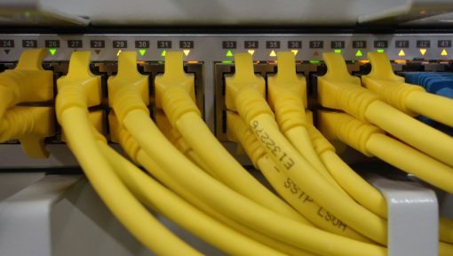 Closeup of Ethernet switch for IP Networking with lots of yellow cables