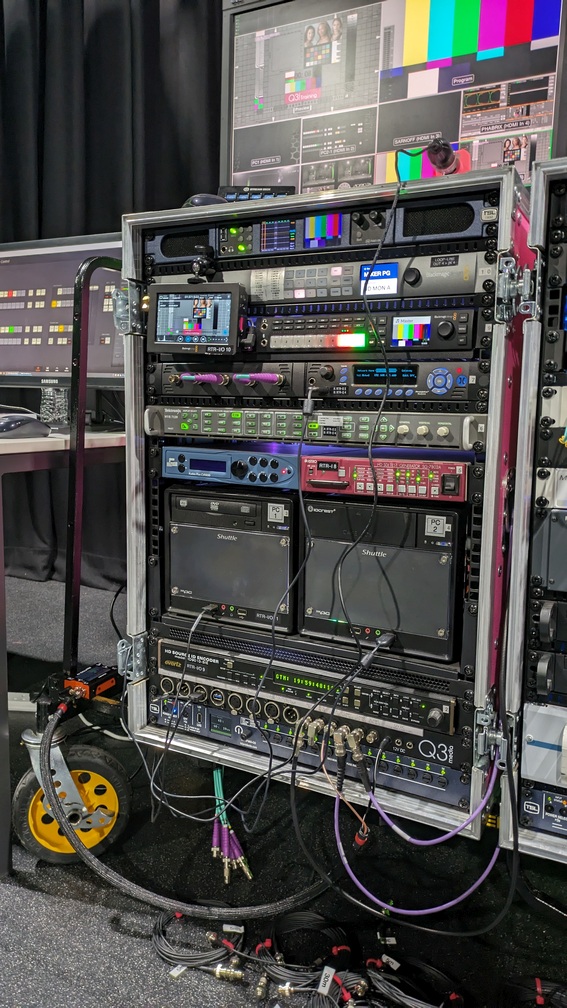 BigPinkDemoKit- HD Rack (small) HD Demo Rack on a trolley pictured alongside a desk where a PC monitor showing the ATEM vision mixer control software can be seen
